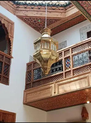 a chandelier hanging from the ceiling of a building at Riad Joseph in Fès