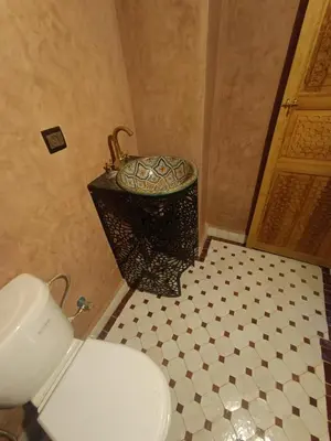 a bathroom with a toilet and a sink in it at Riad Joseph in Fès