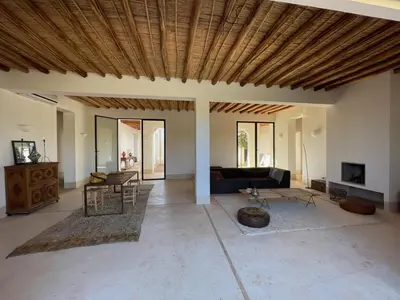 a living room with a couch and a table at Villa les 3 Palmiers B&B in Jdiouat