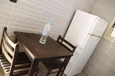 a bottle of water sitting on a table next to a refrigerator at agdz in Agdz