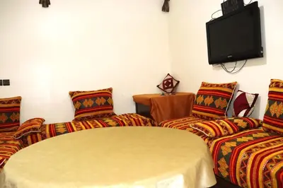 a living room with two couches and a flat screen tv at agdz in Agdz