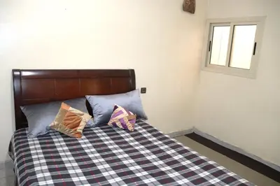 a bedroom with a bed with three pillows on it at agdz in Agdz