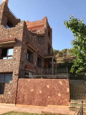 a large brick building with a stone wall at villa maya in Ourika