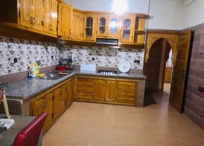 a kitchen with wooden cabinets and a counter top at villa maya in Ourika