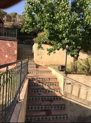 a set of stairs with a fence and a tree at villa maya in Ourika