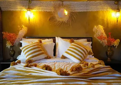 a bed with teddy bears on top of it at Moroccan luxury camp in Merzouga