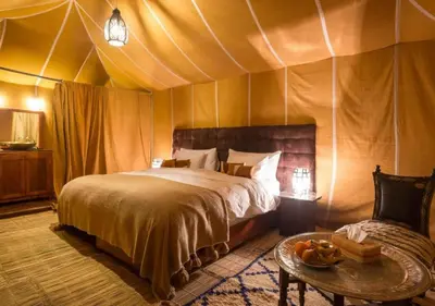 a bedroom with a bed in a tent at Moroccan luxury camp in Merzouga