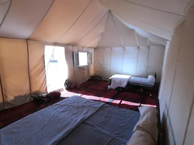 a room with a tent with a bed in it at camp marhaba iriki in Alougoum
