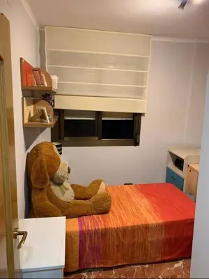 a teddy bear sitting on a bed in a room at inozar in Azrou