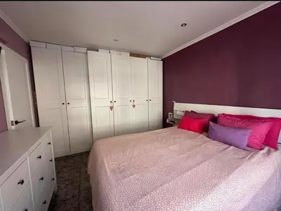 a bedroom with a bed with pink and purple walls at inozar in Azrou