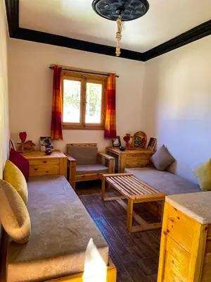 a living room with two couches and a table at Gite Cathedrale Imsfrane in Temga