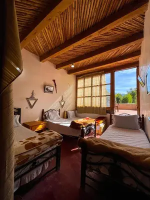 a room with two beds and a window at Gite Cathedrale Imsfrane in Temga