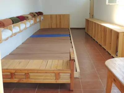 a room with two bunk beds and a table at yagour hebergement in Setti Fatma
