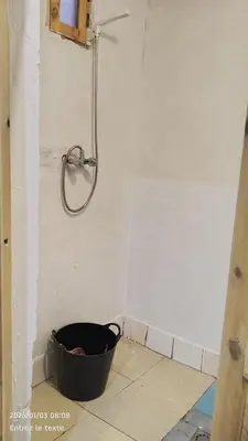 a shower in a bathroom with a bucket at Iriki Desert Camp Foum Zguid in Foum Zguid