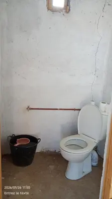 a bathroom with a toilet and a trash can at Iriki Desert Camp Foum Zguid in Foum Zguid