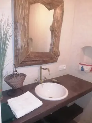 a bathroom with a sink and a mirror at Maison au lac bin el ouidane in Tillouguit nʼAït Isha