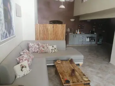 a living room with a couch and a coffee table at Maison au lac bin el ouidane in Tillouguit nʼAït Isha