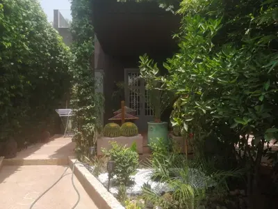 a garden in front of a house with plants at Maison au lac bin el ouidane in Tillouguit nʼAït Isha