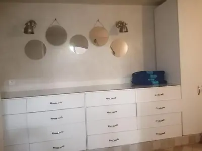 a kitchen with white cabinets and mirrors on the wall at Maison au lac bin el ouidane in Tillouguit nʼAït Isha