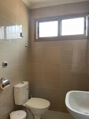a bathroom with a toilet and a sink and a window at Dyafat Abla in Ouarzazate