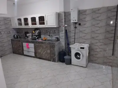 a kitchen with a washer and a washing machine at apartment for rent by days in Zagora