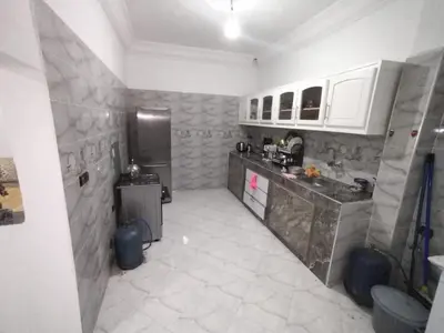 a kitchen with a counter and a refrigerator at apartment for rent by days in Zagora
