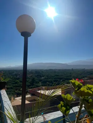 a street light with the sun in the sky at Hôtel Imouzzer in Ourika
