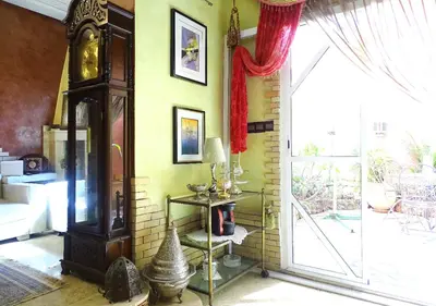 a living room with a clock and a window at Moroccan apartment riad style in Fès