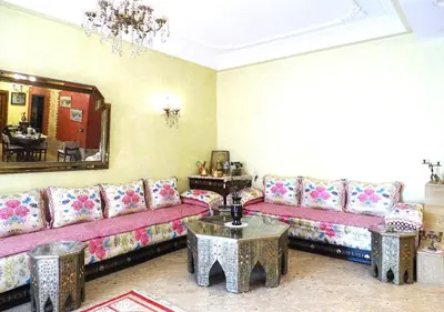 a living room with a couch and a table at Moroccan apartment riad style in Fès