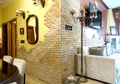 a bedroom with a brick wall next to a bed at Moroccan apartment riad style in Fès