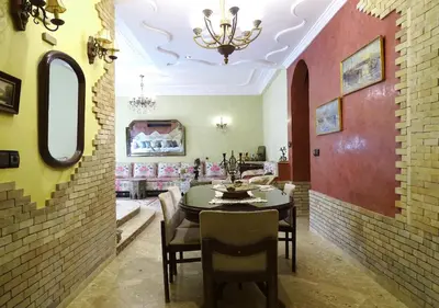 a dining room with a table and chairs at Moroccan apartment riad style in Fès