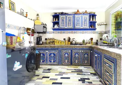a kitchen with blue and white tiles on the floor at Moroccan apartment riad style in Fès