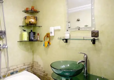 a bathroom with a green sink and a mirror at Moroccan apartment riad style in Fès