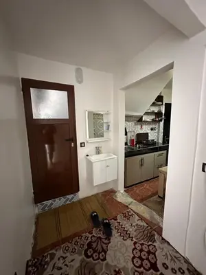 a room with a door and a sink and a kitchen at Taghazout Hostel in Oulad Akkou