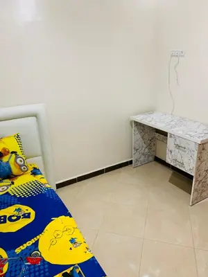a bedroom with a bed and a desk at Al confort in Fès