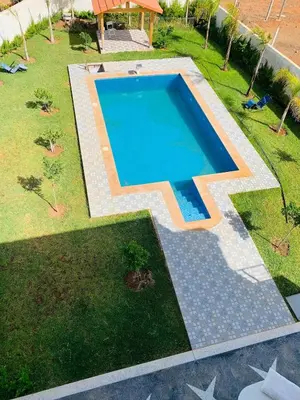 an overhead view of a swimming pool in a yard at Al confort in Fès