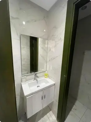 a bathroom with a white sink and a mirror at Luxueux appartement centre ville wifi 200 Mo in Fès