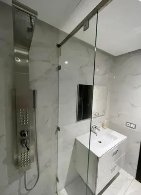 a white bathroom with a shower and a sink at Luxueux appartement centre ville wifi 200 Mo in Fès