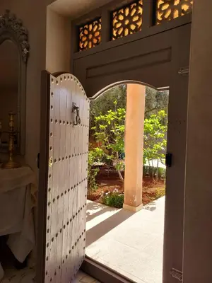 an open door to a patio with a gate at Villa Azuréa with pool 4 bedrooms and 2 living rooms in Ourika