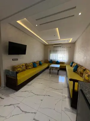 a large living room with a couch and a tv at Etoile De Sidi Harazem in Station de Sidi Harazem
