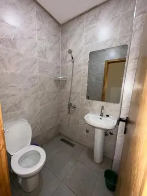a bathroom with a toilet and a sink and a mirror at Etoile De Sidi Harazem in Station de Sidi Harazem