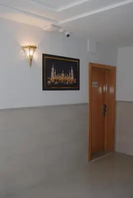 a room with a door and a picture on the wall at Hôtel Asswar Al Madina in Fès