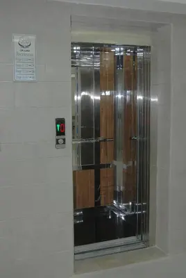 a glass shower in a wall with a green light at Hôtel Asswar Al Madina in Fès