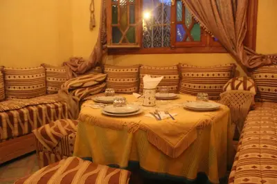 a room with a table with chairs and a tableablish at Dar Lamrani in Rissani