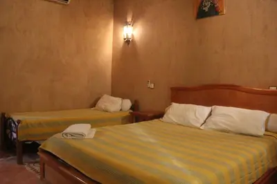 a hotel room with two beds in a room at Dar Lamrani in Rissani