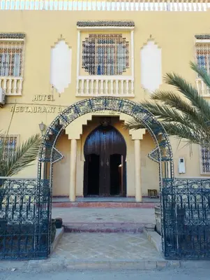 an archway leading to a building with a door at Dar Lamrani in Rissani