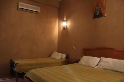 a hotel room with two beds in a room at Dar Lamrani in Rissani