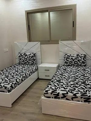 two beds sitting next to each other in a bedroom at Dar location luxury in Meknès
