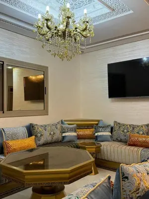 a living room with a couch and a chandelier at Dar location luxury in Meknès