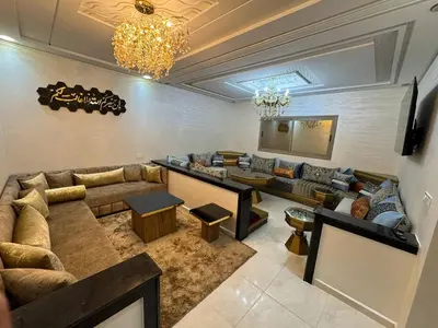 a living room with a couch and a table at Dar location luxury in Meknès